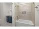 Elegant bathroom featuring tub with tile surround and a blue vanity at 1212 Gunnison Pl, Raleigh, NC 27609