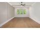 Inviting bedroom featuring hardwood floors, ceiling fan, and plenty of natural light at 1212 Gunnison Pl, Raleigh, NC 27609