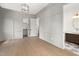Stylish bedroom featuring gray wainscoting, wood floors, walk-in closet, and an adjacent bathroom at 1212 Gunnison Pl, Raleigh, NC 27609