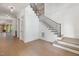 Open foyer with hardwood floors, staircase with iron railing, and elegant white trim and wainscoting at 1212 Gunnison Pl, Raleigh, NC 27609