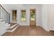 Elegant foyer with hardwood floors, staircase with iron railing, and natural light coming through windows at 1212 Gunnison Pl, Raleigh, NC 27609