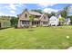Beautiful two-story home with stone accents, manicured lawn, and landscaping create a welcoming curb appeal at 1212 Gunnison Pl, Raleigh, NC 27609