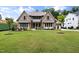 Charming two-story home featuring stone accents, multi-pane windows, manicured landscaping, and a lush green lawn at 1212 Gunnison Pl, Raleigh, NC 27609