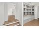 Hallway with hardwood floors, natural light and a built-in bookcase at 1212 Gunnison Pl, Raleigh, NC 27609