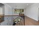 Hallway with hardwood floors, decorative staircase and natural light at 1212 Gunnison Pl, Raleigh, NC 27609