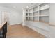 Open hallway with hardwood floors and a built-in bookcase with bench seating at 1212 Gunnison Pl, Raleigh, NC 27609