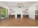 Open living room featuring hardwood floors, a fireplace, built-in cabinets and shelving, and natural light at 1212 Gunnison Pl, Raleigh, NC 27609