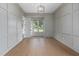 Bright living room featuring panel molding, hardwood floors, and a modern light fixture at 1212 Gunnison Pl, Raleigh, NC 27609