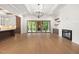 Spacious living room with hardwood floors, fireplace, modern lighting, and outdoor access at 1212 Gunnison Pl, Raleigh, NC 27609