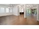 Spacious living area with hardwood flooring, large windows, and stylish light fixtures at 1212 Gunnison Pl, Raleigh, NC 27609