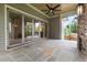Covered outdoor patio with stone floors, ceiling fan, and outdoor fireplace at 1212 Gunnison Pl, Raleigh, NC 27609