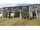 Charming backyard featuring well-maintained lawn, a covered patio, and lush landscaping, perfect for relaxation at 1218 Tredenham Way, Durham, NC 27703