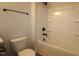 Neutral bathroom featuring a shower/tub, modern black fixtures and tiled walls at 1218 Tredenham Way, Durham, NC 27703