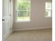 Neutral bedroom featuring a large window, neutral carpet, and bright light at 1218 Tredenham Way, Durham, NC 27703