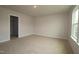 Spacious bedroom featuring neutral walls, soft carpet, and a walk-in closet for storage at 1218 Tredenham Way, Durham, NC 27703