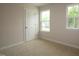 Neutral bedroom featuring a large window, neutral carpet, and bright light at 1218 Tredenham Way, Durham, NC 27703
