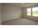 Bright bedroom featuring neutral walls, plush carpet, and windows that flood the room with natural light at 1218 Tredenham Way, Durham, NC 27703