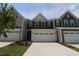 Charming townhome with attached two-car garage and a concrete driveway at 1218 Tredenham Way, Durham, NC 27703
