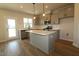 Modern eat-in kitchen featuring an island with bar seating, stainless appliances, and sleek cabinets at 1218 Tredenham Way, Durham, NC 27703
