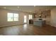 Open concept living area showcasing hardwood floors and an adjacent eat-in kitchen at 1218 Tredenham Way, Durham, NC 27703