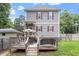 Back exterior featuring gray siding, red shutters, a wooden deck and a fenced yard at 1304 Castlebay Rd, Durham, NC 27703