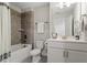 Bathroom with tiled shower and bath, a toilet and single vanity with storage underneath at 1304 Castlebay Rd, Durham, NC 27703