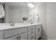 Bright bathroom featuring double sink vanity, undermount sinks, modern faucets, and white shaker cabinets at 1304 Castlebay Rd, Durham, NC 27703