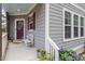 Inviting front porch with cozy seating and colorful flowers, creating a warm welcome to the home at 1304 Castlebay Rd, Durham, NC 27703