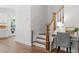 Hallway featuring hardwood floors, stairs, and a built-in desk area with a chair at 1304 Castlebay Rd, Durham, NC 27703