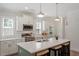 Bright and modern kitchen featuring a large island, white cabinets, and stainless steel appliances at 1304 Castlebay Rd, Durham, NC 27703