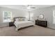 Cozy main bedroom featuring carpet, a ceiling fan, and matching nightstands at 1304 Castlebay Rd, Durham, NC 27703
