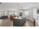 Open concept living area featuring a kitchen island, dining space, and comfortable living room at 1304 Castlebay Rd, Durham, NC 27703