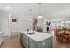 Spacious open floor plan connecting kitchen island, dining area, and living room with a fireplace at 1304 Castlebay Rd, Durham, NC 27703