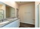 Bathroom with double sink vanity featuring granite counters and wood-look flooring at 1444 Heron Pond St, Raleigh, NC 27604
