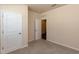Neutrally painted bedroom with carpet flooring, a door, and access to a bathroom at 1444 Heron Pond St, Raleigh, NC 27604