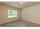 Bright bedroom with carpeted floor, a window, and neutral wall color at 1444 Heron Pond St, Raleigh, NC 27604