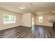 Light-filled living space boasts wood-look floors, a sliding glass door, and multiple windows at 1444 Heron Pond St, Raleigh, NC 27604