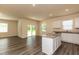 Bright open-concept living space featuring wood-look floors and natural light from sliding glass doors at 1444 Heron Pond St, Raleigh, NC 27604