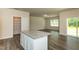 Open-concept living room and kitchen design with granite island and ample storage at 1444 Heron Pond St, Raleigh, NC 27604