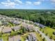 An aerial view of the neighborhood shows many homes nestled in a beautiful wooded landscape at 1502 Spring Overlook Ln, Hillsborough, NC 27278