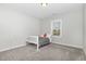 Neutral bedroom with a window, light-colored carpet, and simple furnishings, ready to personalize at 1502 Spring Overlook Ln, Hillsborough, NC 27278