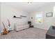 Light-filled bedroom offering a couch, floating shelves, and ample room for relaxation and hobbies at 1502 Spring Overlook Ln, Hillsborough, NC 27278