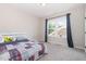 Bright bedroom boasts natural light through a large window and cozy quilt bedspread at 1502 Spring Overlook Ln, Hillsborough, NC 27278