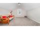 Loft-style bonus room with a futon, carpet, and a window, perfect for relaxing or as a playroom at 1502 Spring Overlook Ln, Hillsborough, NC 27278