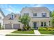 Charming two-story home featuring a landscaped front yard, a teal front door and an attached two-car garage at 1502 Spring Overlook Ln, Hillsborough, NC 27278
