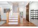 Open foyer showcasing hardwood floors, a staircase, and a sliding barn door for added privacy at 1502 Spring Overlook Ln, Hillsborough, NC 27278