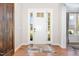 Bright foyer featuring hardwood floors and a stylish front door with sidelights for plenty of light at 1502 Spring Overlook Ln, Hillsborough, NC 27278