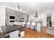 Open concept kitchen with a large island, breakfast bar, stainless hood, and seamless flow into the living area at 1502 Spring Overlook Ln, Hillsborough, NC 27278