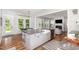 Spacious kitchen with granite counters, an island with seating, and a view into the living room at 1502 Spring Overlook Ln, Hillsborough, NC 27278