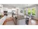 Granite island features a stainless sink and dishwasher in this open kitchen concept with access to the back porch at 1502 Spring Overlook Ln, Hillsborough, NC 27278